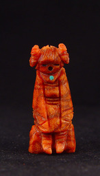 A Zuni Corn Maiden fetish carved in Apple Coral